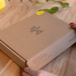 Brown box with 'Your Friends Are Here' text on a wooden surface