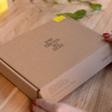 Brown box with 'Your Friends Are Here' text on a wooden surface