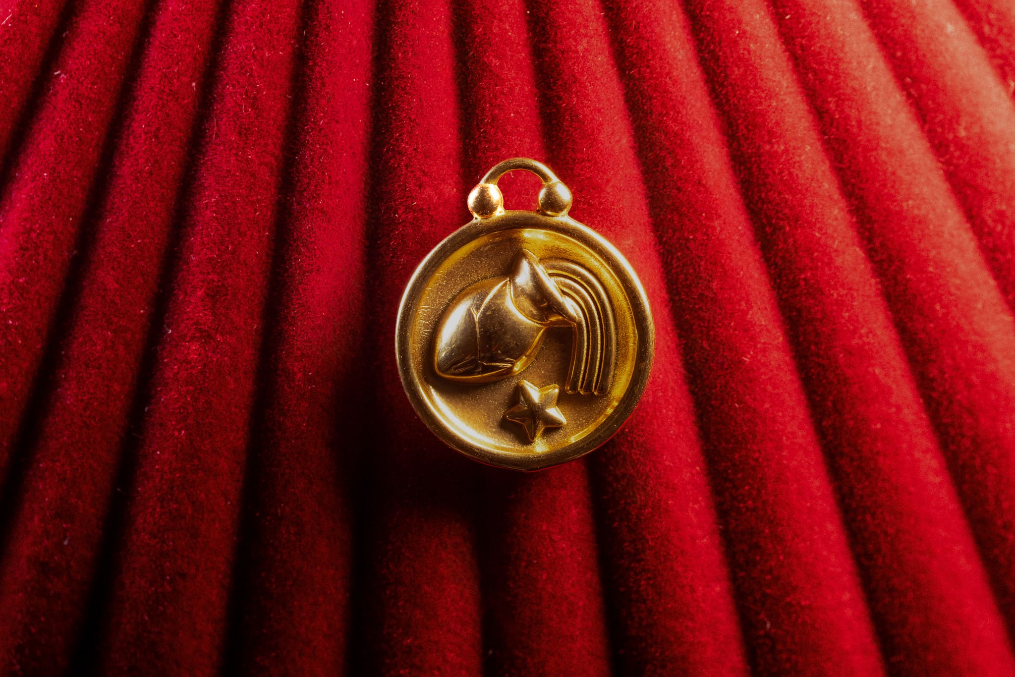 Aquarius pendant on a red textured fabric background