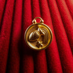 Aquarius pendant on a red textured fabric background