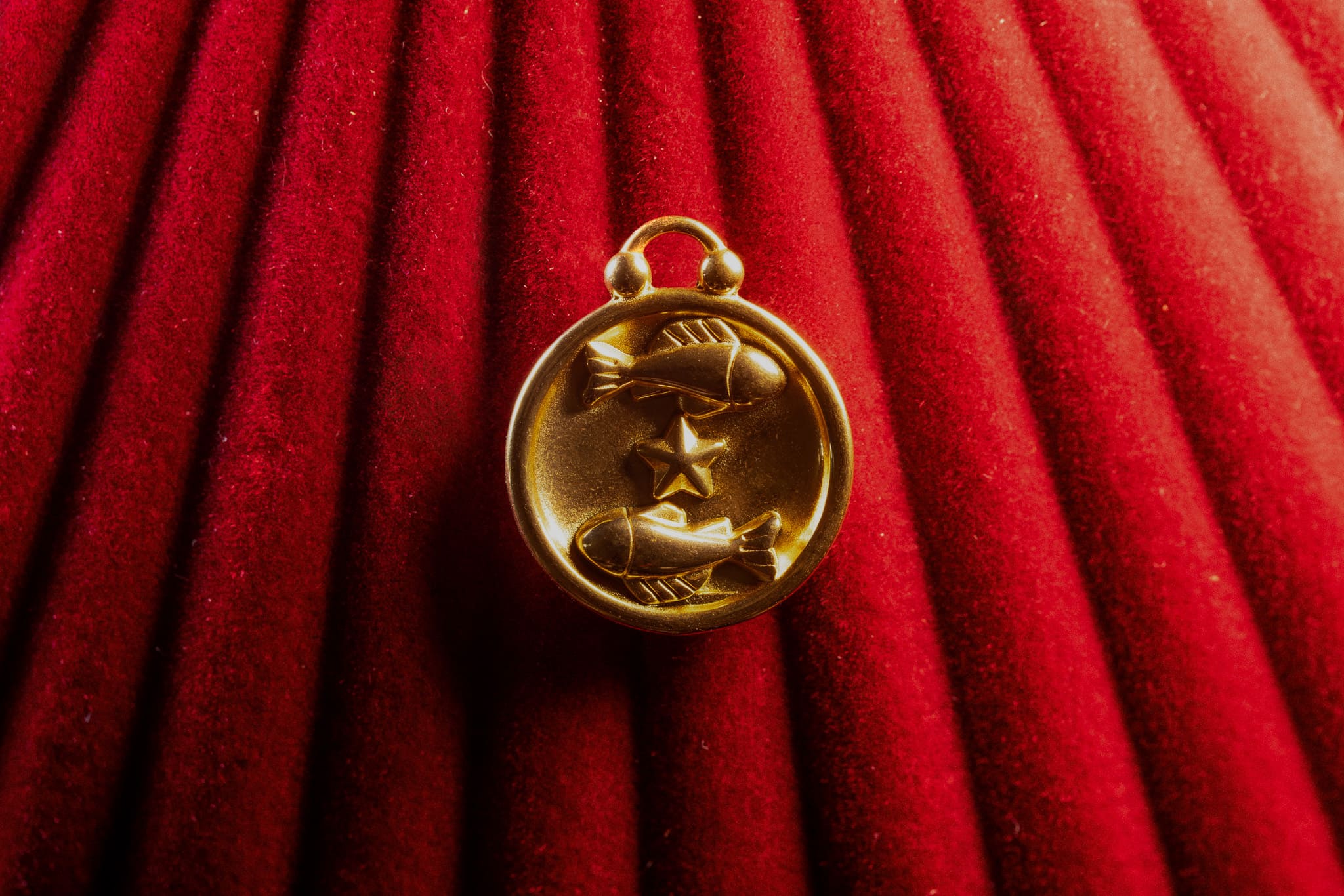 Pisces pendant a red textured background