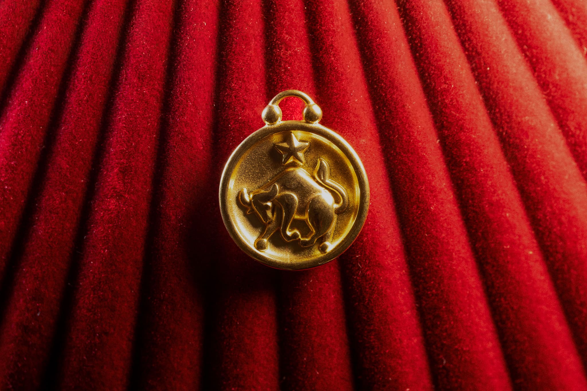 Taurus pendant on a red textured background