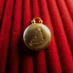 Gold Pendant watch with Capricorn Constellation on a red textured background